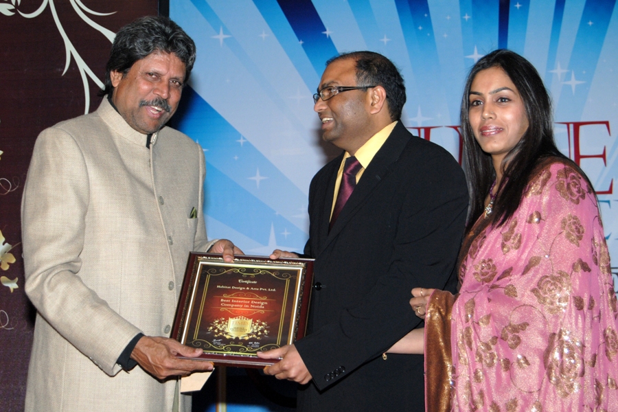 Ajay Jain receiving the Best Interior Design & Build Company award from cricket legend Kapil Dev, presented by Times Research